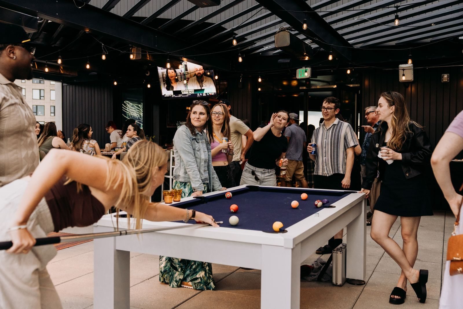 A rooftop pool tournament crowd on the event deck