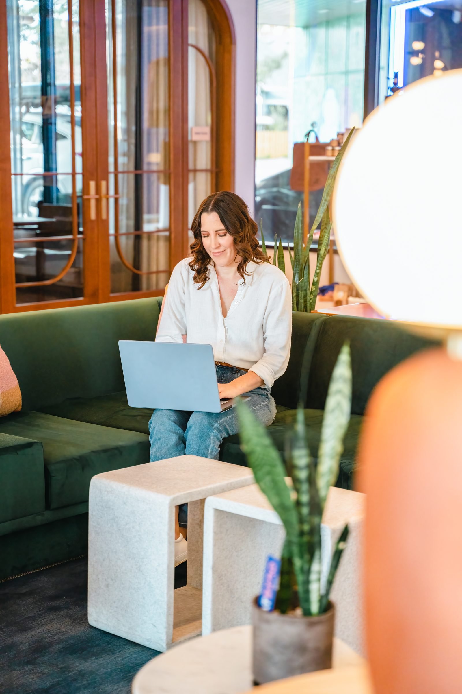Guest working on a laptop in the Catbird lobby