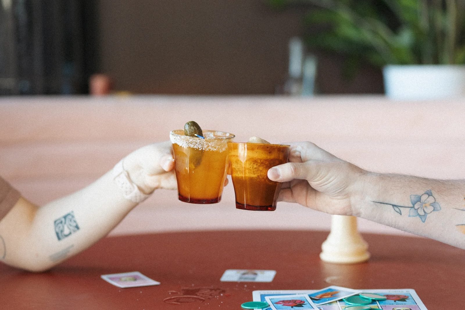 Two cocktails cheersing over a table at a RiNo spot